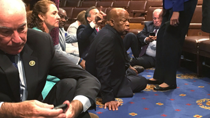 A photo shot and tweeted from the floor of the House by U.S. House Rep. John Yarmuth shows Democratic members of the U.S. House of Representatives, including Rep. Joe Courtney (L) and Rep. John Lewis (C) staging a sit-in on the House floor "to demand action on common sense gun legislation" on Capitol Hill in Washington, United States, June 22, 2016. REUTERS/U.S. Rep. John Yarmuth/Handout