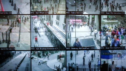 A panel of TV screens displays security footage from across New York City.