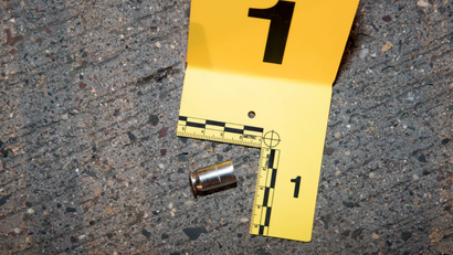 A shell casing from a bullet fired at Philando Castile lies outside his car