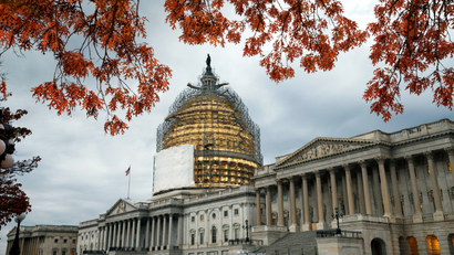 FILE - This Nov. 13, 2014, file photo shows the U.S. Capitol Dome, in Washington, surrounded by scaffolding for a long-term repair project, and framed by the last of autumn's colorful leaves. Like a student who waited until the night before a deadline, lawmakers resuming work Monday will try to cram two years of leftover business into two weeks while avoiding a government shutdown.