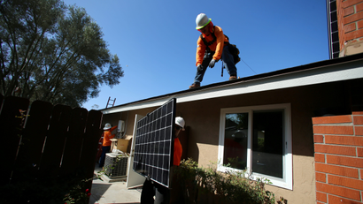 Rooftop solar panel installation workers typically earn less than their peers in fossil fuels.