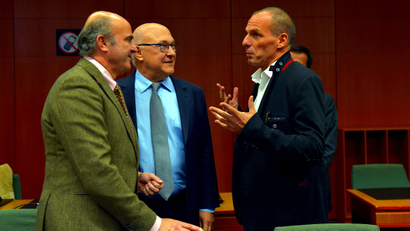 (L-R) Spain's Finance Minister Luis de Guindos and France's Finance Minister Michel Sapin chat with Greece's Finance Minister Yanis Varoufakis during an extraordinary euro zone finance ministers meeting (Eurogroup) to discuss Athens' plans to reverse austerity measures agreed as part of its bailout, in Brussels February 20, 2015. Euro zone finance ministers reached an agreement on Friday to extend heavily indebted Greece's financial rescue by four months, officials on both sides said.