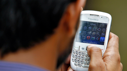 A man checks his Blackberry for email