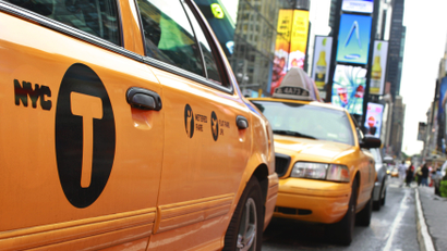 A New York City taxicab drives through Times Square in New York