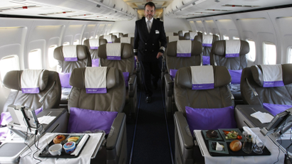 OpenSkies Airline Senior Flight Officer Andy Pomeroy walks down the aisle of one of its Boeing 757-200 jets that features 84 business class seats only cabins in Dulles Virginia