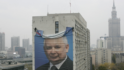 A banner of the leader of Poland's PiS (Law and Justice) party, Jaroslaw Kaczynski, is taken down from a building in the centre of Warsaw October 30, 2007.