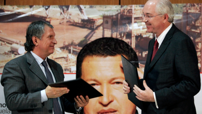 Venezuela's Oil Minister Rafael Ramirez, right, and Igor Sechin, chief executive of Russian energy company Rosneft, smile at each other after a signing ceremony in Caracas, Venezuela, Tuesday, Jan. 29, 2013.