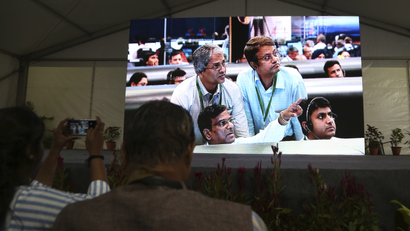 Live pictures of Indian Space Research Organization (ISRO) scientists reacting are displayed on a big screen at their Telemetry, Tracking and Command Network facility in Bangalore, India