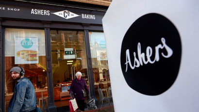 A woman leaves Ashers bakery in Belfast. March 26, 2015. Ashers is to face a discrimination case from the Equality Commission after it refused to make a cake bearing a pro-gay marriage slogan on it which was to be given to Andrew Muir, Northern Ireland's first openly gay mayor. The bakers refused to make the cake on the grounds that it contradicted their religious beliefs according to local media. REUTERS/Cathal McNaughton - LM1EB3Q0XKO01