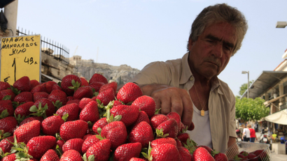 A greengrocer displays strawberries at his stall at Monastiraki market, central Athens.
