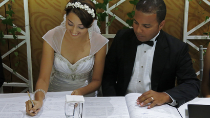 Couple signs the wedding certificate