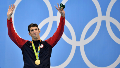 United States' Michael Phelps celebrates after he was awarded the gold medal during the medal ceremony for the men's 200-meter individual medley final during the swimming competitions at the 2016 Summer Olympics, Thursday, Aug. 11, 2016, in Rio de Janeiro, Brazil.