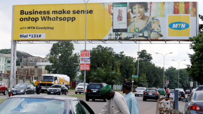 A billboard advertises an MTN service for businesses that use WhatsApp in Nigeria