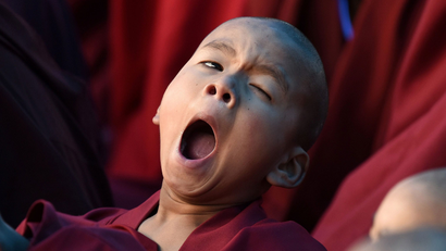 Novice monk yawns as he attends teachings by Tibetan spiritual leader Dalai Lama in Bomdila