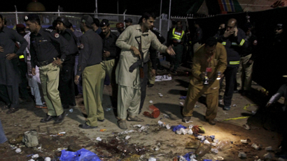 Security officials gather at the site of a blast outside a public park in Lahore, Pakistan, March 27, 2016.