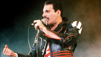 FILE - In this 1985 file photo, singer Freddie Mercury of the rock group Queen, performs at a concert in Sydney, Australia. Queen guitarist Brian May says an asteroid in Jupiter's orbit has been named after the band's late frontman Freddie Mercury on what would have been his 70th birthday, it was reported on Monday, Sept. 5, 2016. May says the International Astronomical Union's Minor Planet Centre has designated an asteroid discovered in 1991, the year of Mercury's death, as "Asteroid 17473 Freddiemercury." (AP Photo/Gill Allen, File)