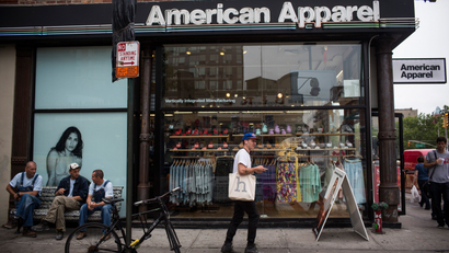 NEW YORK, NY - JUNE 19: People walk past an American Apparel store on June 19, 2014 in New York City.