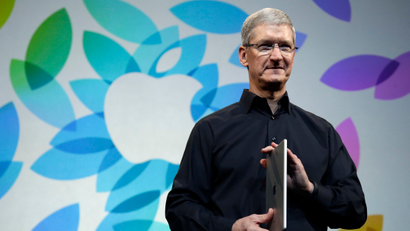 Apple CEO Tim Cook holds an iPad Air