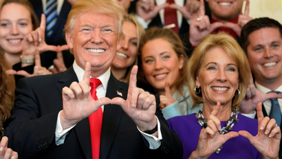 US President Trump and Secretary DeVos make "U" symbols with Utah Skiing team in Washington