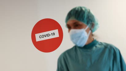 A hospital staff member is pictured before treating a patient suffering from the coronavirus disease (COVID-19) at Hospital del Mar, where an additional ward has been opened to deal with an increase in coronavirus patients in Barcelona, Spain July 15, 2021.