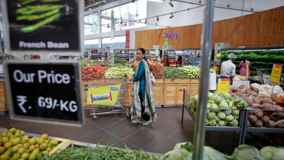 Women buying vegetables in a supermarket in India