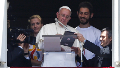 The pope uses an iPad at a podium