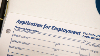 An employment application form is displayed during a restaurant job career fair in New York