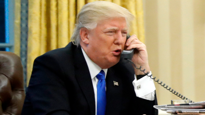 FILE - In this Jan. 28, 2017, file photo, President Donald Trump speaks on the phone with Prime Minister of Australia Malcolm Turnbull in the Oval Office of the White House in Washington. Trump, who blasted Hillary Clinton for using a personal email server, might be a walking magnet for eavesdropping and malware if he is using an unsecured cellphone to chat with foreign leaders. Trump has been handing out his cellphone number to counterparts around the world, urging them to call him directly to avoid the red tape of diplomatic communications. The practice has raised concern about the security and secrecy of the U.S. commander-in-chief's communications.