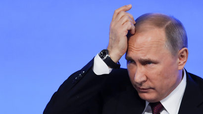 Vladimir Putin scratching his head