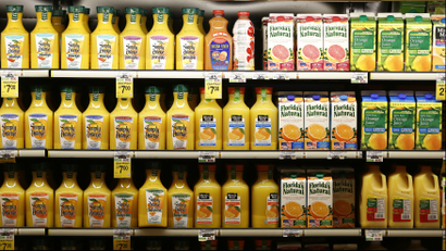 Orange juice on a supermarket shelf.