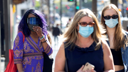 People wearing face protective masks walk on Hollywood Blvd during the outbreak of the coronavirus disease (COVID-19), in Los Angeles