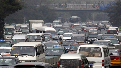 Cars sit in a traffic jam as they make their way along a main road in central Beijing April 10, 2009. Vehicle sales in China, the world's largest car market, climbed to a record in March, extending gains from the previous month, helped by government policy measures to bolster demand in both urban and rural areas. A total of 1.10 million vehicles was sold last month, up from 1.06 million units in March 2008, which previously posted the highest monthly sales, data from the China Association of Automobile Manufacturers (CAAM) showed on Thursday. REUTERS/David Gray