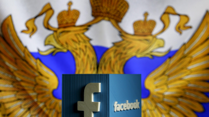 Facebook logo in front of Russian flag