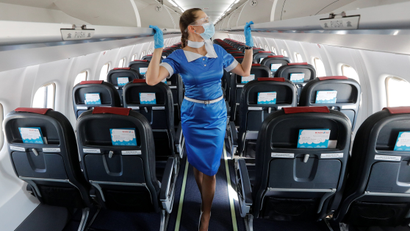 A flight attendant walks through an empty passenger plane of Ukraine's Windrose Airlines