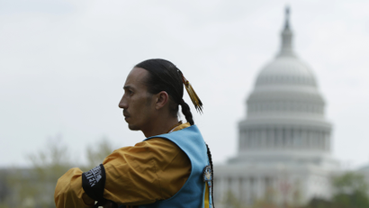 Native American man in front of US capitol building