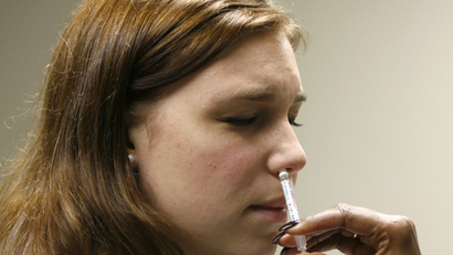A person receives an inhaled flu vaccine.