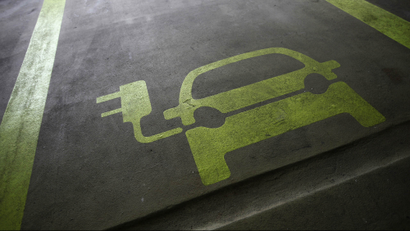 A sign is painted on a parking space for electric cars inside a car park in Hong Kong January 29, 2012. Many of the headlines out of autoshows in the past couple of years have been captured by the launch of electric cars such as Nissan's Leaf, the Tesla sports car, plug-ins like General Motors' Chevrolet Volt, and the latest incarnation of the Toyota Prius. Other manufacturers including BMW, Rolls Royce and Porsche have presented electric-powered prototypes. On the basis of this, one could be forgiven for thinking the auto industry is betting big on electric power. Yet few auto executives share the optimism of Renault and Nissan chief executive Carlos Ghosn who has repeatedly said he sees electric vehicles making up 10 percent of all sales in 2020. A survey of 200 auto industry executives conducted by KPMG released on Monday gave an average forecast for electric vehicles to account for 6-10 percent of global auto sales in 2025, more bullish than oil companies BP and Exxon who expect electric cars to make up no more than 4-5 percent of all cars globally in 20-30 years. Picture taken January 29, 2012. To match Insight ELECTRIC-CAR/BIG OIL REUTERS/Tyrone Siu (CHINA - Tags: BUSINESS ENERGY ENVIRONMENT SCIENCE TECHNOLOGY)
