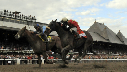 V.E. Day, left, with jockey Javier Castellano up, moves past Wicked Strong right, with jockey Rajiv Maraghto up, to win the Travers Stakes horse race at Saratoga Race Course in Saratoga Springs, N.Y., Saturday, Aug. 23, 2014. (AP Photo /Hans Pennink)