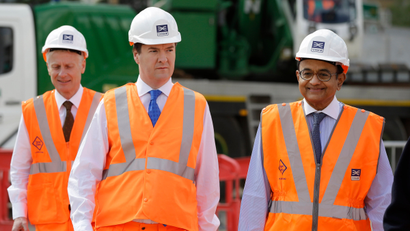 Britain's Chancellor of the Exchequer George Osborne, center, accompanied by India's Finance Minister Palaniappan Chidambaram, right, tour the Pudding Mill Lane Crossrail construction site, in east London, Thursday, May 16, 2013. ()