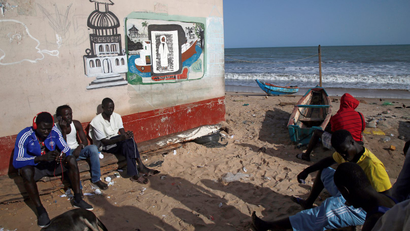 Fishermen are seen as they sit next to the seashore in Banjul, Gambia April 7, 2017.