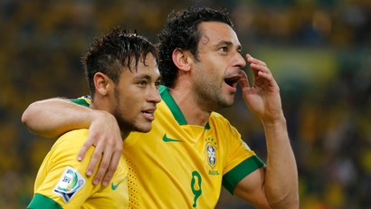 Brazil's Fred (R) celebrates with teammate Neymar after scoring a second half goal against Spain during the Confederations Cup final soccer match at the Estadio Maracana in Rio de Janeiro June 30, 2013.