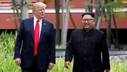 U.S. President Donald Trump and North Korean leader Kim Jong Un walk after lunch at the Capella Hotel on Sentosa island in Singapore June 12, 2018.
