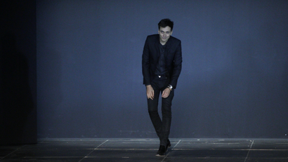 French designer Hedi Slimane appears at the end of his Spring/Summer 2013 women's ready-to-wear fashion show for French fashion house Saint Laurent Paris during Paris fashion week October 1, 2012.