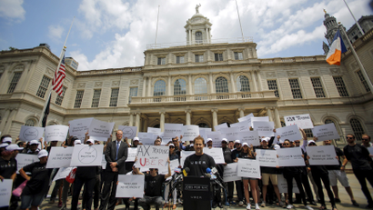 Uber riders and drivers take part in a rally on steps of New York City Hall in June 2015.