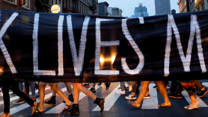 People take part in a protest against police brutality and in support of Black Lives Matter during a march in New York