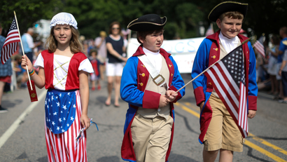 Children in costumes march down Main Street during the annual Fourth of July parade in Barnstable Village
