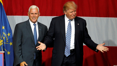 Republican U.S. presidential candidate Donald Trump (R) and Indiana Governor Mike Pence (L) wave to the crowd before addressing the crowd during a campaign stop at the Grand Park Events Center in Westfield, Indiana, July 12, 2016.