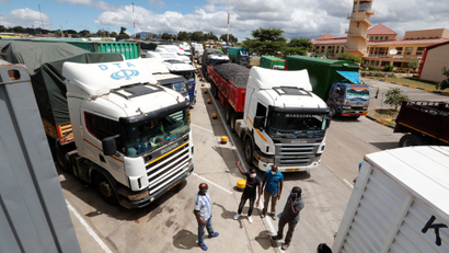 Truck drivers near their parked vehicles at the Namanga border crossing point between Kenya and Tanzania in Kenya.