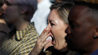 A woman yawns after meditating during an event in The Gherkin in London