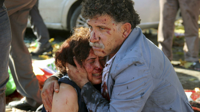 An injured man hugs an injured woman after an explosion during a peace march in Ankara, Turkey.